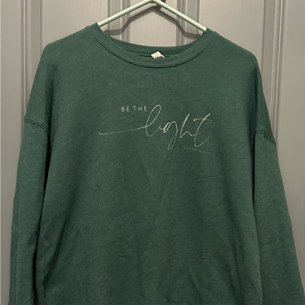 Green sweatshirt with religious saying